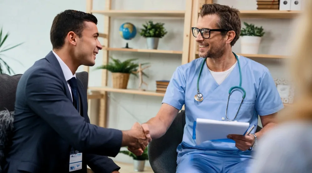 Young medical billing consultant shaking hands with a nutrition clinician