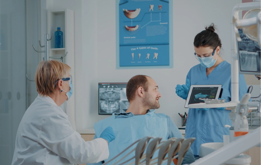 Dental team discussing treatment with a patient
